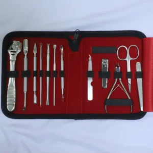 Complete manicure pedicure kit displayed in premium red zippered case with all 12 stainless steel grooming tools organized in elastic loops.